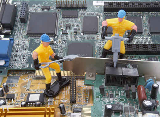 whimsical 2 toy workmen on circuit boards